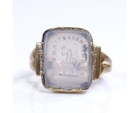 A 19th century unmarked gold intaglio carved chalcedony panel seal ring, with Totem emblem and motto "In Adversis Etiam Fida"