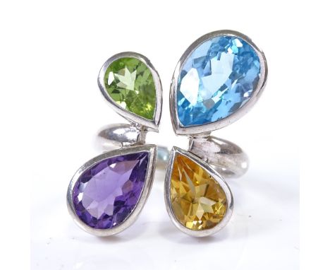 A modern handmade unmarked silver pear-cut gem set dress ring, gems include amethyst, citrine, blue topaz and peridot, settin