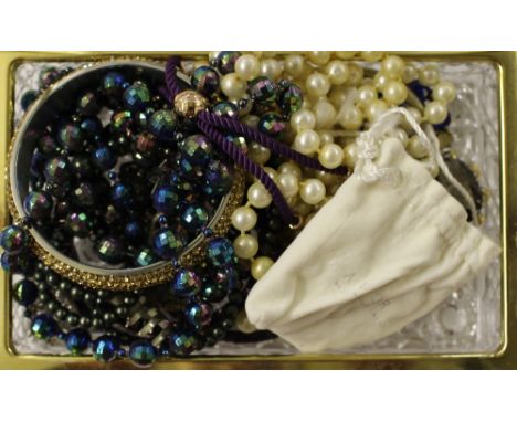 A glass trinket box of costume jewellery