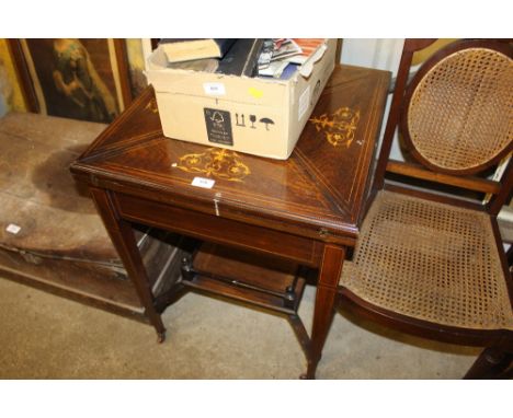 An Edwardian rosewood and inlaid envelope card table 