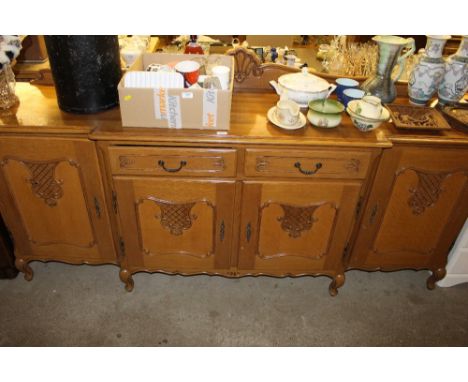 A Continental style light oak break front sideboard fitted two drawers
