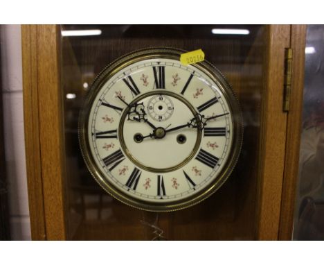 A large light oak cased regulator two hole wall clock