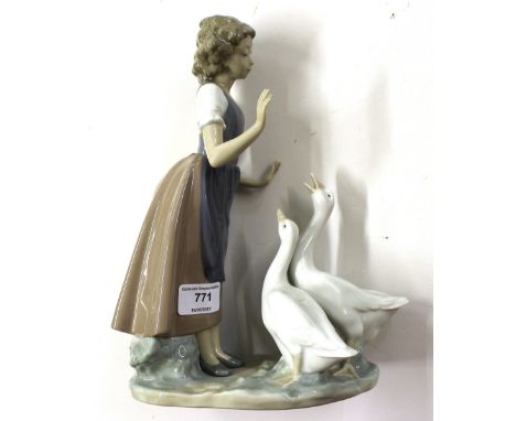 A Nao figurine in the form of a female with two geese