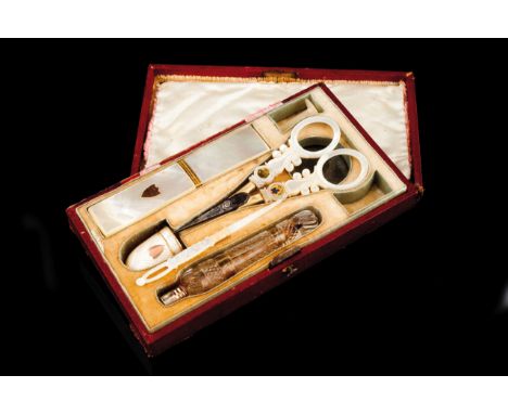 A sweing set  Mother of pearl, gilt metal, steel and cut crystal instruments Comprising: scissors, thimble, needle-case, reel