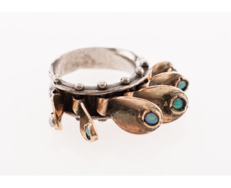 A unique opal ring, a hammered finish white metal ring set with six articulated rose metal leaves, each 'leaf' is set with a 