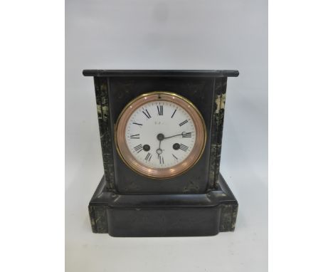 A slate and marble mantel clock stamped Paris to the dial.