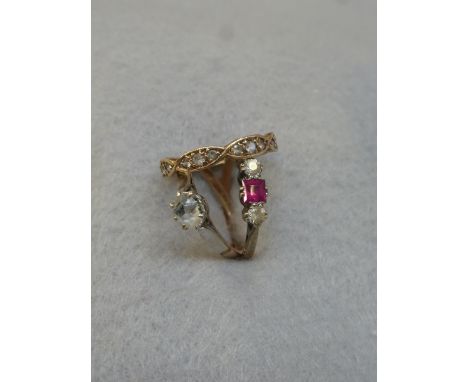 A gold (unmarked) and faux diamond eternity ring, a 9ct gold and platinum single stone ring, and a ruby and two stone ring.