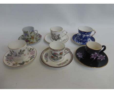 Six assorted cabinet coffee cans and saucers by various makers including Royal Worcester and Palissy "Orchid" pattern.