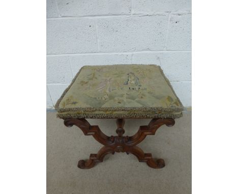 An early 19th Century carved walnut tapestry covered stool.