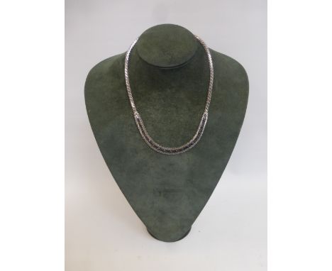 An 18ct white gold necklace set with seventeen light blue sapphires, the necklace in the form of a horizontal and herring-bon