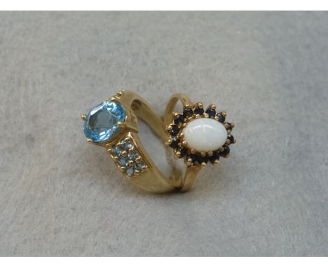 A 9ct gold opal and sapphire dress ring, size O, and a 9ct gold and possibly blue topaz dress ring, size N/O.