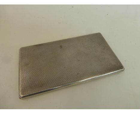 A silver cigarette case with engine turned decoration, maker - Adie Brothers, Birmingham, 1937.