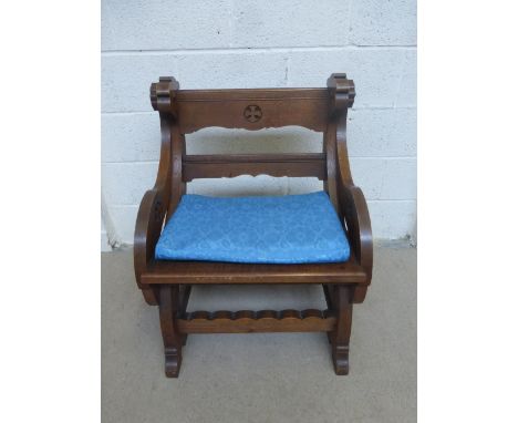 Tabernacle U.R.C. Chippenham, a light oak Glastonbury elbow chair of unusual form with carved ecclesiastical design.
