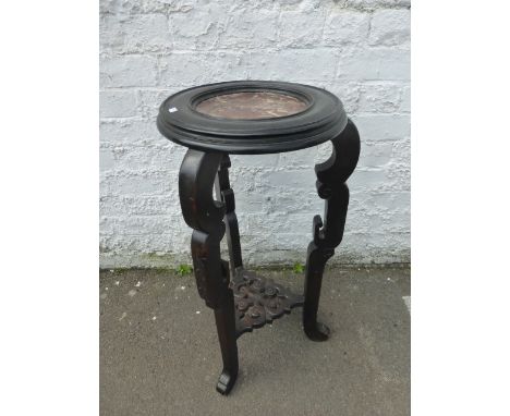 An ebonised and marble topped plant/lamp stand with pierced undertier.