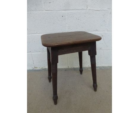 A 19th Century oak rectangular stool with reeded decoration, raised on four angular turned reeded supports.