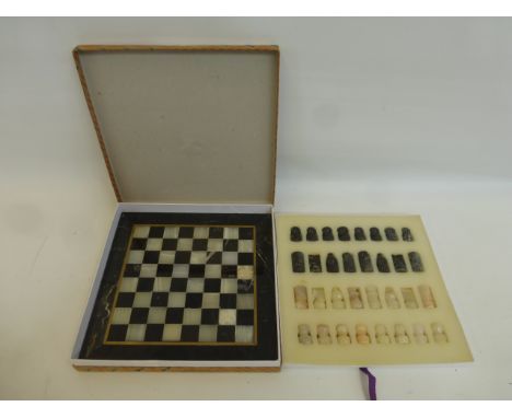 A cased marble chess set with board.