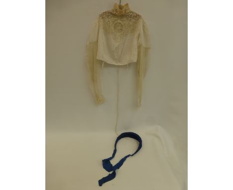 A high collared lady's blouse with exquisite floral designs to lace across the neck, decolletage, upper back and cuffs, hook 