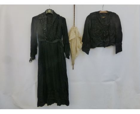 A black silk dress with lace detailing, a blouse with lace and bead embellishment, an umbrella etc.