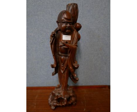 An oriental carved hardwood figural Buddha lamp base 