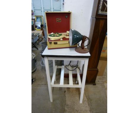 A painted wooden and enamelled top kitchen island, a table lamp and one other 