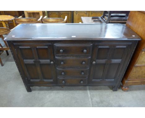 An Ercol Old Colonial dark elm sideboard 