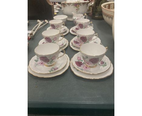 A CROWN REGENT PART TEASET WITH ROSES DESIGN AND GILT AROUND THE RIMS AND HANDLES TO INCLUDE CREAM JUG, SUGAR BOWL, CUPS, SAU