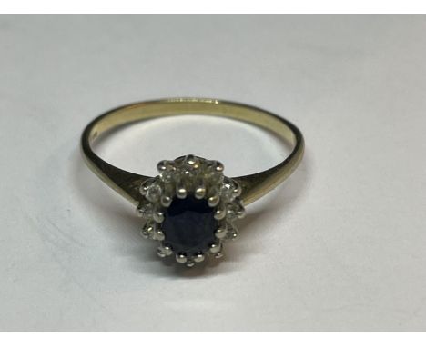 A 9 CARAT GOLD RING WITH A CENTRE SAPPHIRE SURROUNDED BY DIAMONDS SIZE J/K 