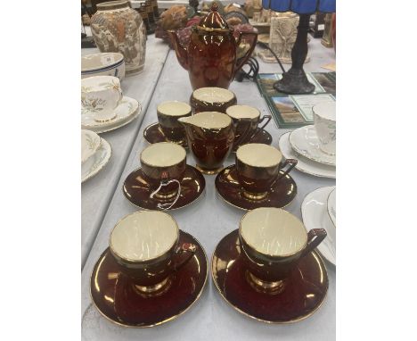 A CARLTON WARE COFFEE SET IN A CRISOM LUSTRE WARE TO INCLUDE COFFEE SET, SUGAR BOWL, CREAM JUG, CUPS AND SAUCERS 