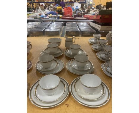 A PARAGON TEASET IN WHITE WITH GILT RIMS AND HANDLES TO INCLUDE CREAM JUG, SUGAR BOWL, CUPS, SAUCERS AND SIDE PLATES 