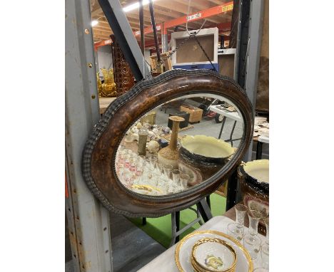 A LATE VICTORIAN WALNUT FRAMED OVAL BEVELLED MIRROR 84CM X 53CM 