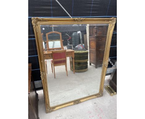 A LARGE GILT FRAMED MIRROR - 52" X 41" 