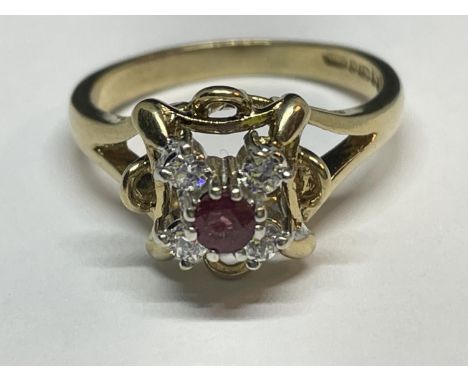 A 9 CARAT GOLD RING WITH CENTRE RUBY SURROUNDED BY CUBIC ZIRCONIAS SIZE K 