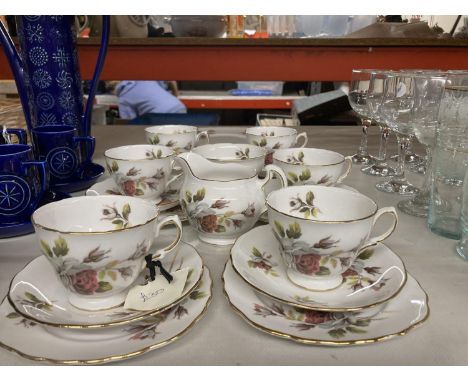 A ROYAL VALE ROSE PATTERNED TEASET TO INCLUDE A CAKE PLATE, CREAM JUG, SUGAR BOWL, CUPS, SAUCERS AND SIDE PLATES 