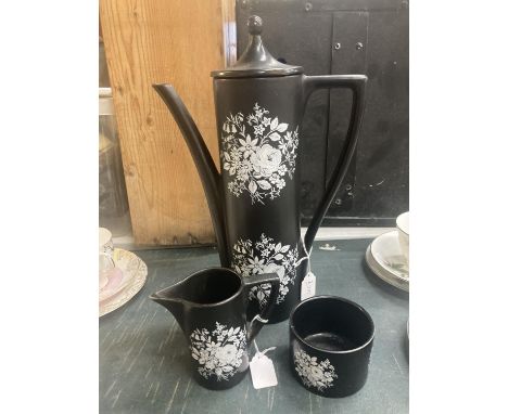 A PORTMEIRION BLACK WITH FLORAL DESIGN COFFEE POT, CREAM JUG AND SUGAR BOWL 