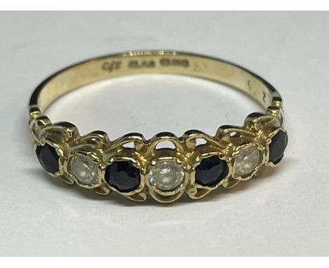 A 9 CARAT GOLD RING WITH FOUR SAPPHIRES AND THREE CUBIC ZIRCONIAS IN A LINE SIZE Q/R 