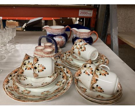 A QUANTITY OF OSBOURNE CHINA TO INCLUDE CUPS, SAUCERS, SIDE PLATES, EGG CUPS IN A STAND PLUS TWO RIDGWAYS JUGS WITH SCENES OF