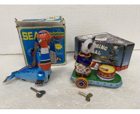 TWO VINTAGE BOXED TIN PLATE TOYS - A SEAL PLAYING BALL AND A DRUMMING PANDA 