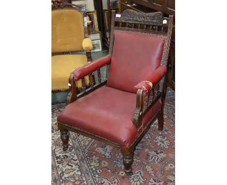 A Victorian mahogany gentleman's armchair, carved and spindled top rail, padded back, seat and arms, turned forelegs, ceramic