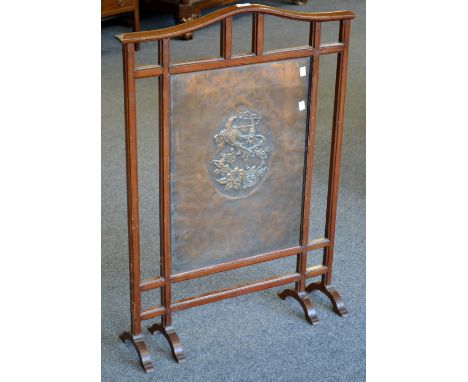 A late 19th century mahogany and copper  fire screen in the Japanese taste, the copper panel with embossed oval of mons, phoe