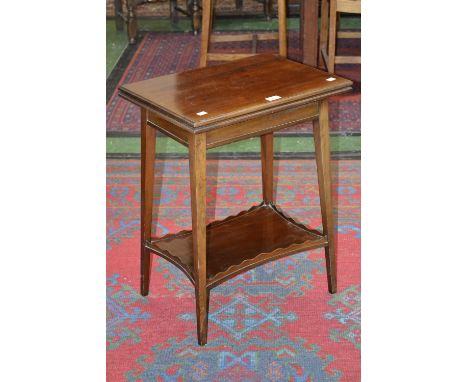 An Edwardian mahogany card table, by Howard & Sons, London, folding top, rectangular undertier with wavy gallery, ivorine lab