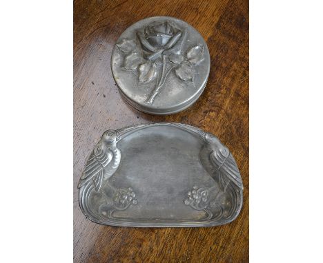An Art Nouveau pewter tray cast with stylised birds perched on fruiting vines, and an Etains D'Art  pewter circular dish and 