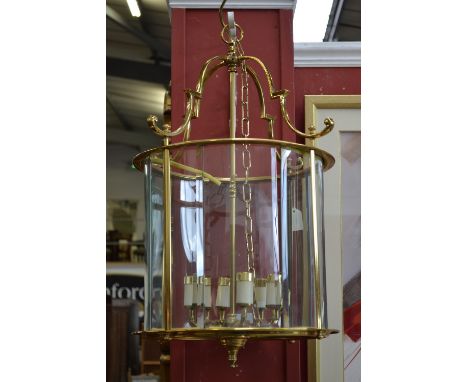 A large brass cylindrical six light hall lantern, bevelled glass panels