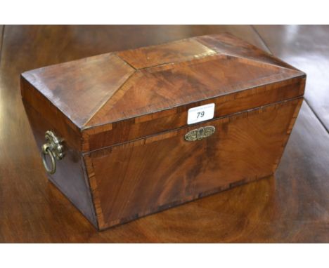 A Regency rosewood crossbanded mahogany sarcophagus tea caddy, hinged cover enclosing a bowl flanked by a pair of lidded comp