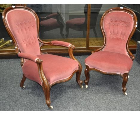 A pair of Victorian gentleman's and a lady's button upholstered spoon back salon chairs. (2)