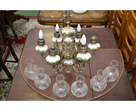 A six branch ceramic and gilt metal electrolier, scrolling branches, etch glass globes.