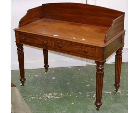 A Victorian mahogany writing desk, three quarter gallery, moulded oversailing top, two short drawers to frieze, turned handle