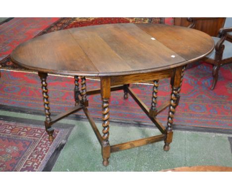 A George VI oak gate leg dining table, turned twisted supports, c1940