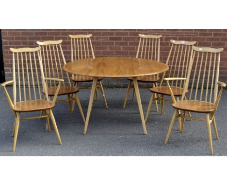 An Ercol Windsor light elm and ash table, four chairs and two open carvers