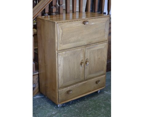 An Ercol Windsor drinks cabinet, light elm and ash, (badge in drawer Hunters of Derby)
