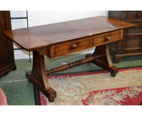 A Victorian flame mahogany sofa table, radiused drop ends, two short drawers to frieze, button handles, shaped end supports, 